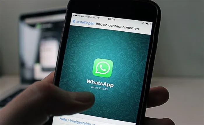 Смартфон с WhatsApp в руке