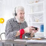 cheerful-senior-man-being-focused-on-video-game